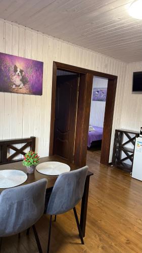 a dining room with a table and two chairs at Гостинний двір" Живиця" ЧАН in Mizhhirʼʼya