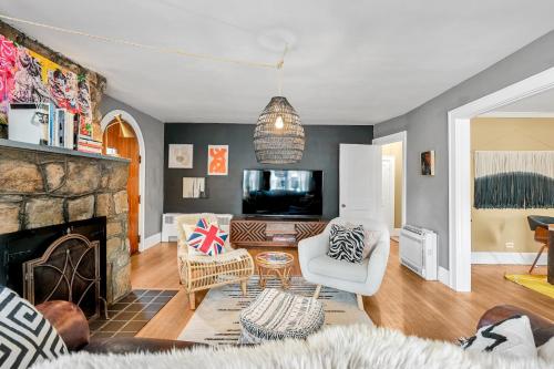 a living room with a fireplace and a tv at Asheville Urban Farmhouse Entire Home 4 mi to DT in Asheville