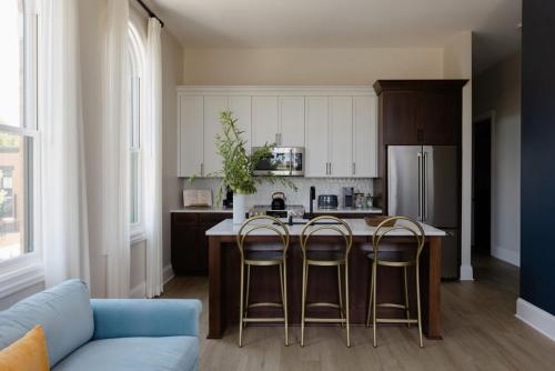 a kitchen with a table and two bar stools at The Purple Martin - The Perch in Louisville