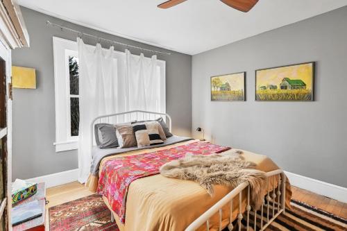 a bedroom with a bed and a window at Asheville Urban Farmhouse Entire Home 4 mi to DT in Asheville