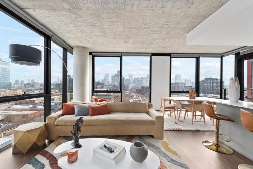 a living room with a couch and a table at Fulbrix Bright Designer Apartments with West Loop Views in Chicago