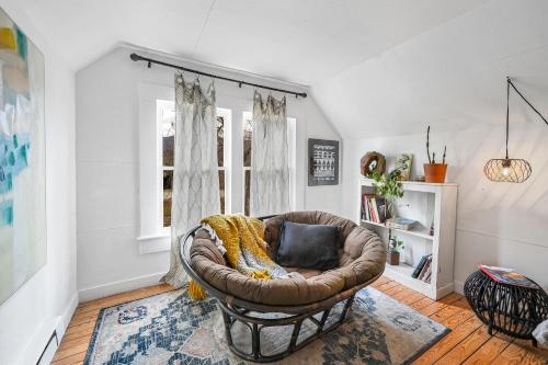 a leather chair sitting in a living room at Asheville Urban Farmhouse Entire Home 4 mi to DT in Asheville