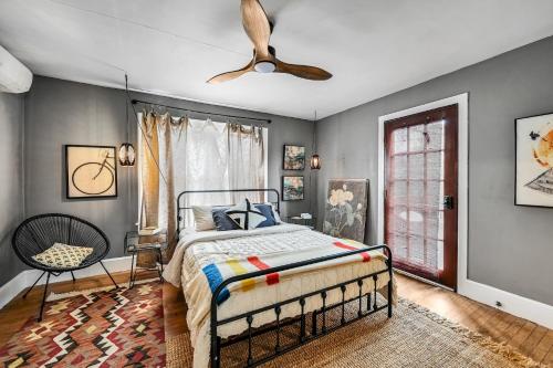 a bedroom with a bed and a ceiling fan at Asheville Urban Farmhouse Entire Home 4 mi to DT in Asheville