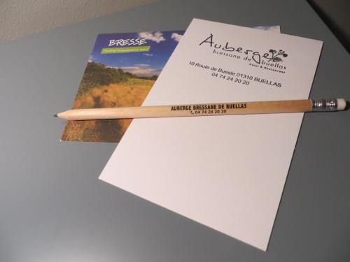 a wooden pencil sitting on top of a piece of paper at Auberge Bressane de Buellas in Buellas
