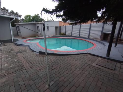 a small swimming pool in a yard with a fence at 04 at Beaumont in King Williamʼs Town