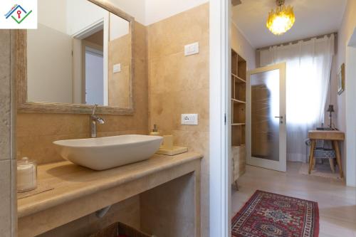 a bathroom with a sink and a mirror at A Casa Di Giò by TuscanyWeGo in Livorno