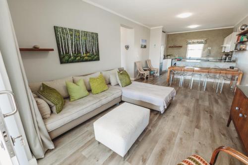 a living room with a couch and a table at Restore your Soul, Boulders Beach, Seaforth, Simon's Town in Simonʼs Town