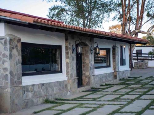 a stone house with a patio at Wine Valley Ranch in Valle de Guadalupe