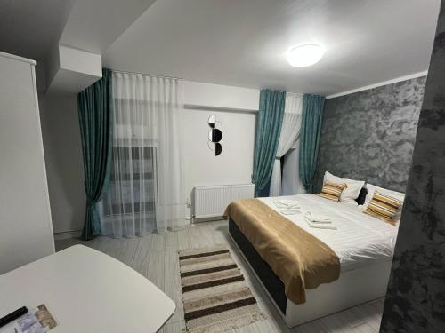 a bedroom with a large bed with green curtains at Grey Boutique Hotel Palas in Iaşi