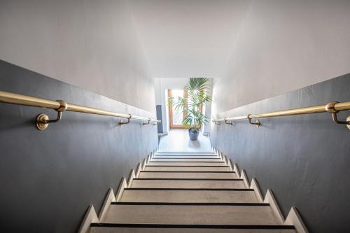 a staircase in a building with a potted plant at Sottoassisi - Guest House in Assisi
