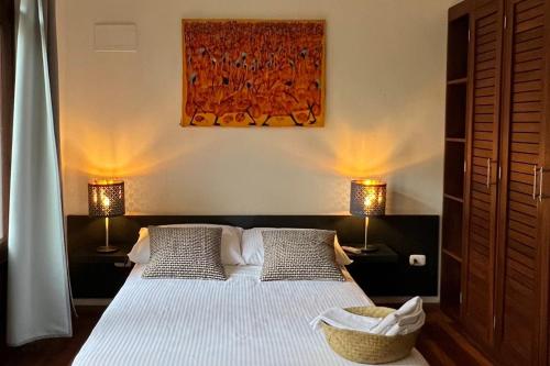 a bedroom with a large bed with two lamps at Paseo Colonial - Leo's Favorite #8 in Santo Domingo