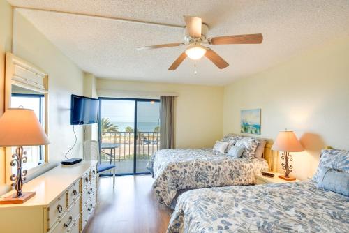 a bedroom with two beds and a ceiling fan at Walk to Madeira Beach Coastal Condo with Balcony in St Pete Beach