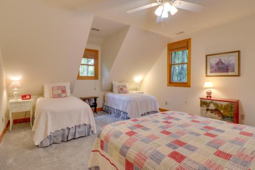 a bedroom with two beds and a ceiling fan at Creekside Family Retreat by Waterfalls and Hiking! in Sapphire