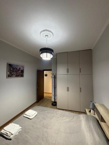 an empty room with a large room with white cabinets at Niki's cozy apartment in Mytilene