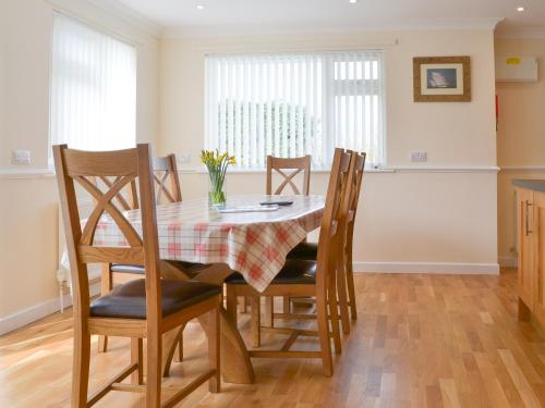a dining room with a table and chairs at Driftwood in Port Isaac
