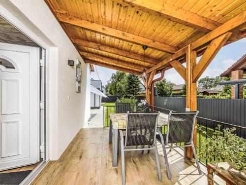 a patio with a table and chairs and a wooden pergola at Holiday Home Mediana by Interhome in Balatonmáriafürdő