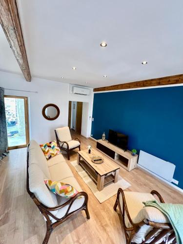 a living room with a couch and a table at Seven Keys - La cour du Barres in Saint-Vincent-de-Barrès