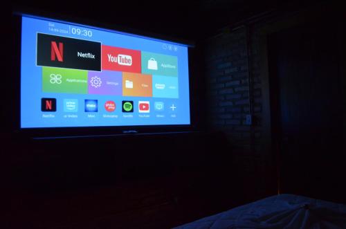 a television screen in a dark room at Pousada Alto Pirapitinga in Resende