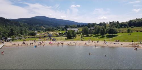 a group of people in the water at a beach at Dom Puchacza w Lądku-Zdroju in Lądek-Zdrój