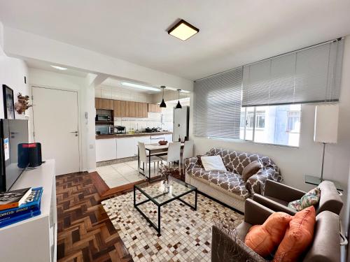a living room with a couch and a table at Barriga Verde in Florianópolis