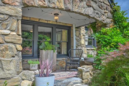 a stone house with a chair and a window at Asheville Urban Farmhouse Entire Home 4 mi to DT in Asheville