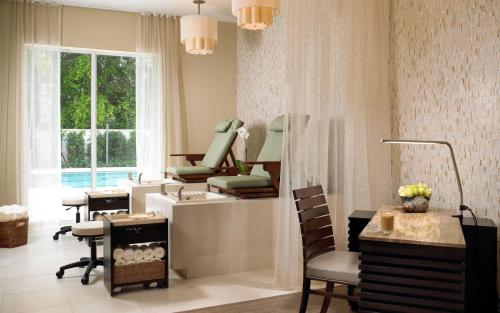 a hair salon with a mirror and a hair dryer at The Seagate in Delray Beach