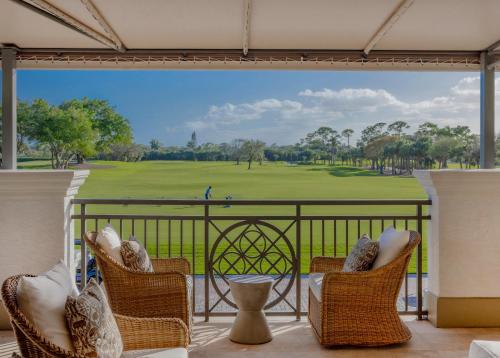a balcony with chairs and a view of a golf course at The Seagate in Delray Beach