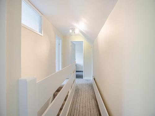 a hallway of a house with white walls and a window at Casa Mia in Terrington Saint John