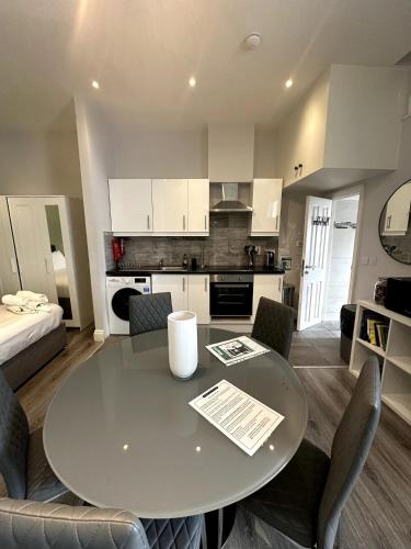 a kitchen and dining room with a table and chairs at Abbey Apartments in Dublin