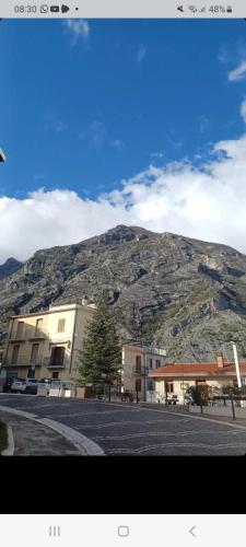 a mountain in the distance with a building and a parking lot at Casa Fara in Fara San Martino