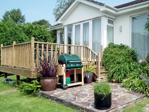 a barbecue grill on a patio in front of a house at Moonrakers in Ruan Lanihorne