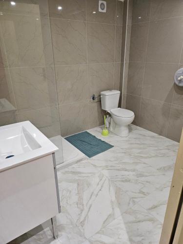 a bathroom with a toilet and a sink at hotel Victoria in Perpignan