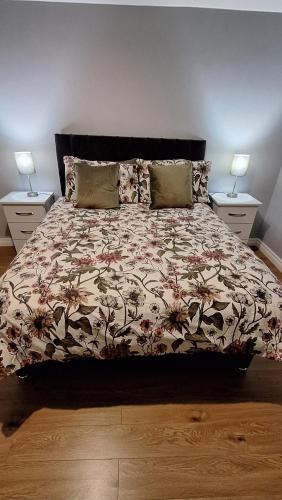 a bedroom with a large bed with two night stands at White Mountain Cottage in Newry