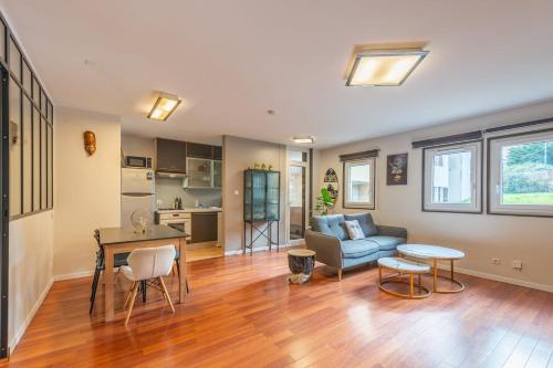 un salon avec un canapé et une table dans l'établissement Les Feuillettes, à Annecy