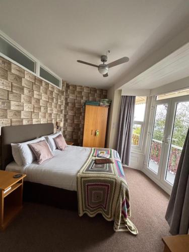 a bedroom with a bed with a table on it at The Clifton in Shanklin