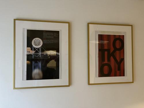 two framed pictures hanging on a wall at Old Town Apartment in Cēsis