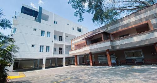 a large building with a parking lot in front of it at Real Guanacaste in San Pedro Sula