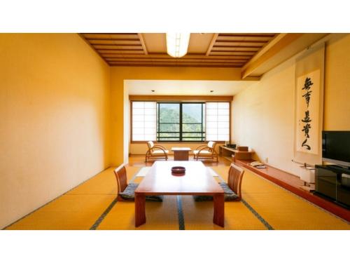 a room with a table and chairs and a television at Miki no Sato Hotel Miki - Vacation STAY 52488v in Gero