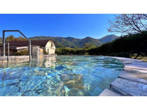 a pool of water with mountains in the background at Miki no Sato Hotel Miki - Vacation STAY 52488v in Gero