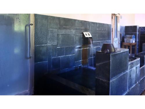 a room with a blue tiled wall at Miki no Sato Hotel Miki - Vacation STAY 52488v in Gero