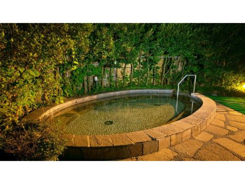 a small pool of water in a stone circle with a fountain at Miki no Sato Hotel Miki - Vacation STAY 51868v in Gero