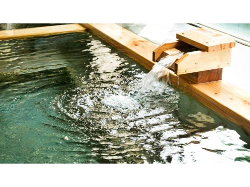 a stream of water coming out of a wooden ramp at Miki no Sato Hotel Miki - Vacation STAY 51868v in Gero