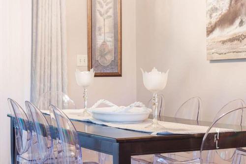 a dining room table with chairs and a plate on it at Elegant Palm Bay Getaway with Large Backyard in Palm Bay