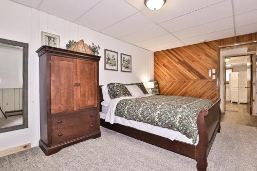 a bedroom with a large bed and a wooden headboard at Boulder Lakehouse in Boulder Junction