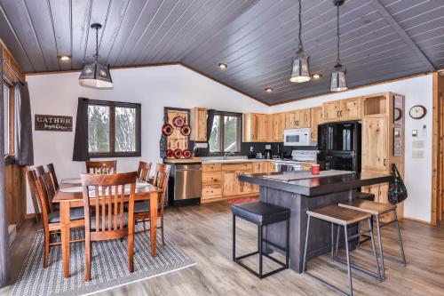 a kitchen with wooden cabinets and a table and chairs at Boulder Lakehouse in Boulder Junction