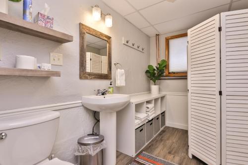 a white bathroom with a sink and a toilet at Boulder Lakehouse in Boulder Junction