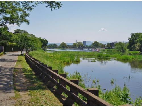 a fence next to a river next to a lake at Smile Hotel Kumamoto Suizenji - Vacation STAY 59267v in Kumamoto