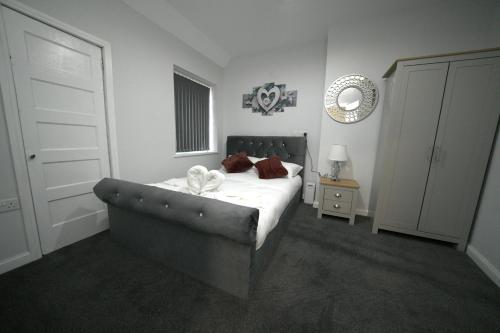 a bedroom with a bed with a white sheets and pillows at Telford Tranquility Apartment Flat 3 for 4 guests in Telford