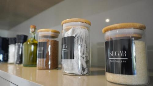 three glass jars sitting on a counter with spices at 110 The Gallery luxury apartment in Knysna