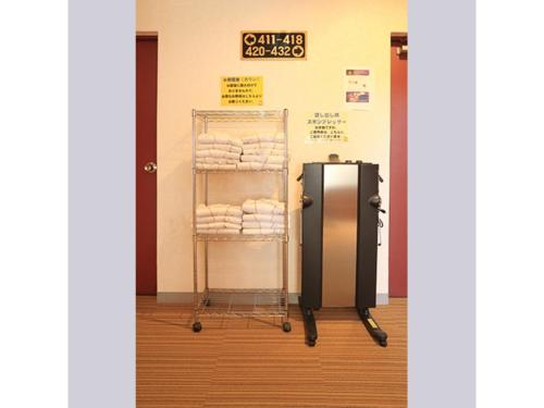 a towel rack with towels on it in a room at Smile Hotel Kumamoto Suizenji - Vacation STAY 59277v in Kumamoto